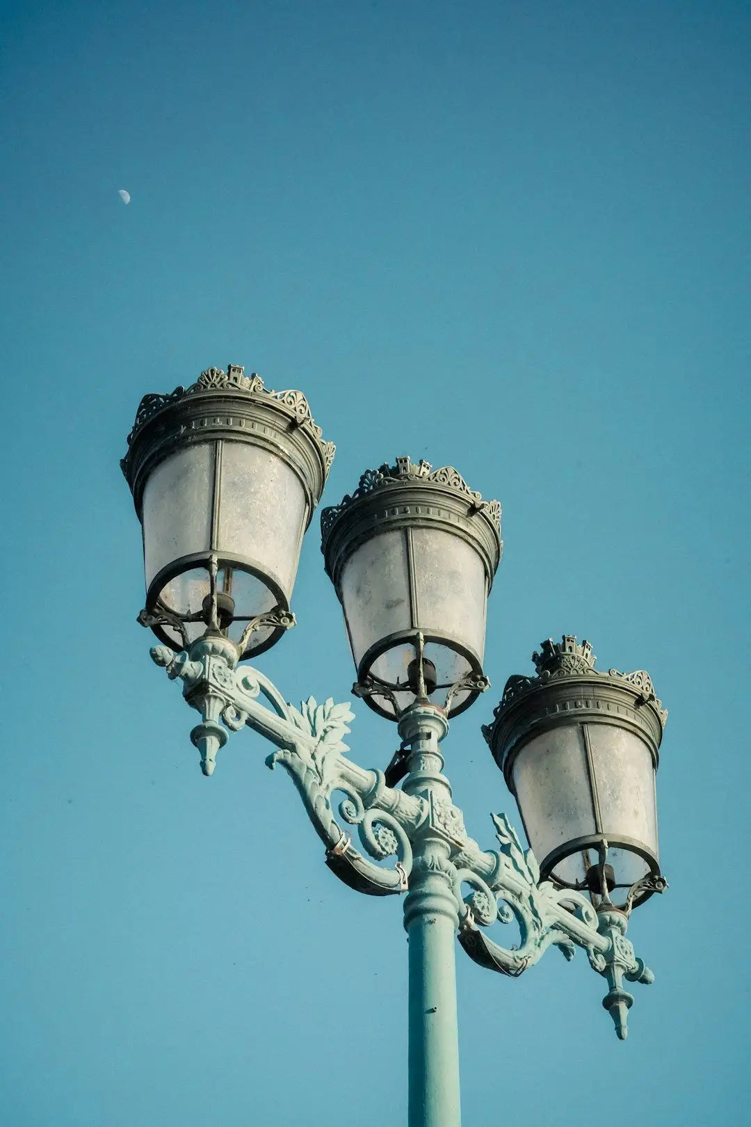 Ornate street lamp with three globular lights enhancing creative picture frames ambiance
