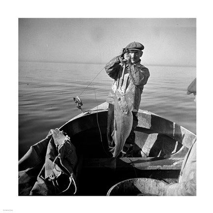 Hauling in a cod aboard a Portuguese fishing dory off Cape Cod, Massachusetts