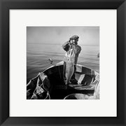 Hauling in a cod aboard a Portuguese fishing dory off Cape Cod, Massachusetts
