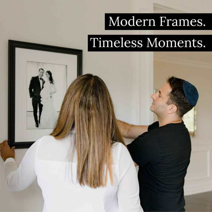 a man standing next to a woman in front of a picture